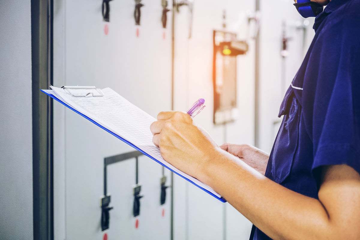 HVAC technician with checklist