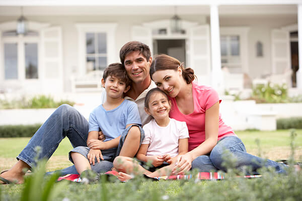 family sitting on grass