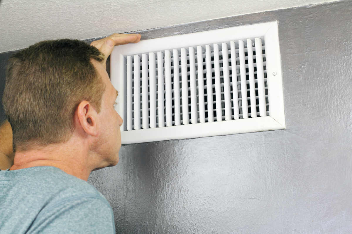 St. Louis man inspecting vent