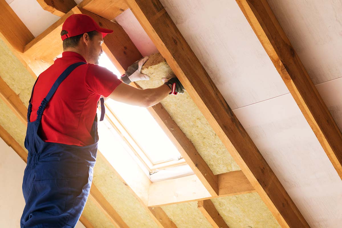 man installing insulation in a St. Louis home